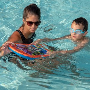 Woman and boy playing in pool